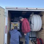 The owner and us going over the settings of the wall spray cellulose machine